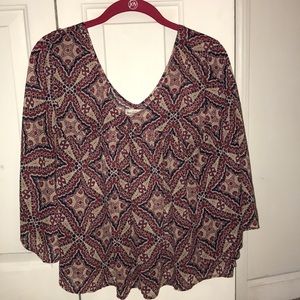 Blouse with three-quarter length sleeves.